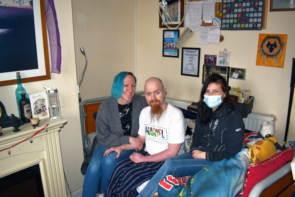 Tim with his support team at home during his complex care journey