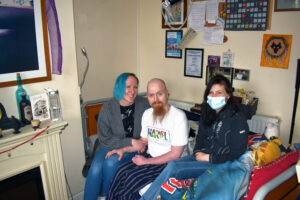 Tim with his support team at home during his complex care journey